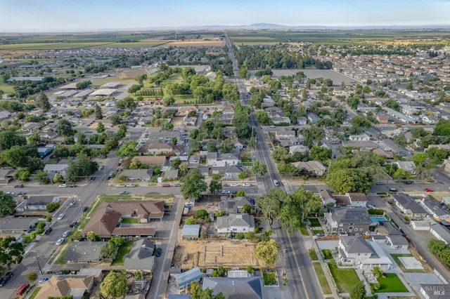 an aerial view of a house with a yard basket ball court and outdoor seating