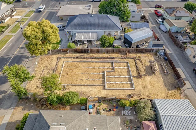 an aerial view of a residential apartment building with a yard
