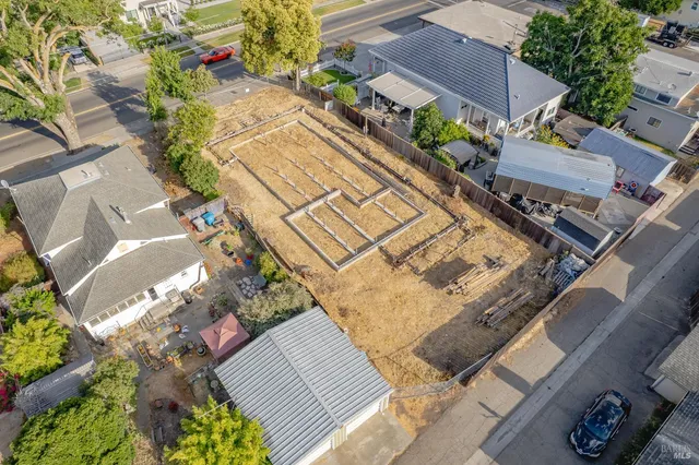 an aerial view of a house with a yard