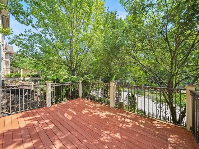 a balcony with wooden floor and lake view