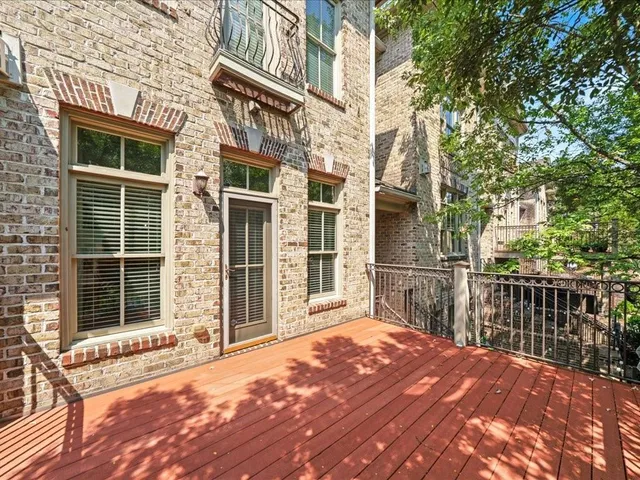 a spacious bedroom with a bed and wooden floor