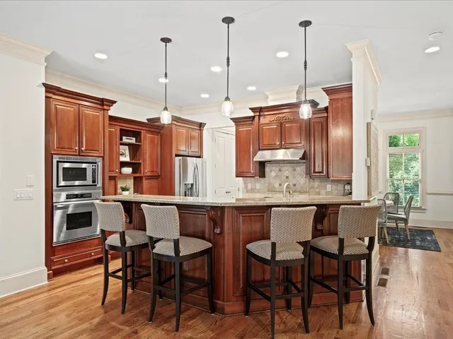 a large kitchen with a table and chairs