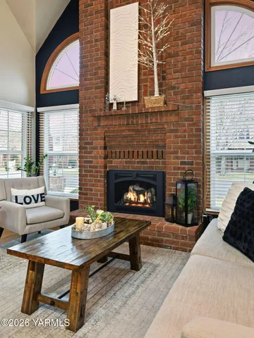 a living room with furniture a fireplace and window