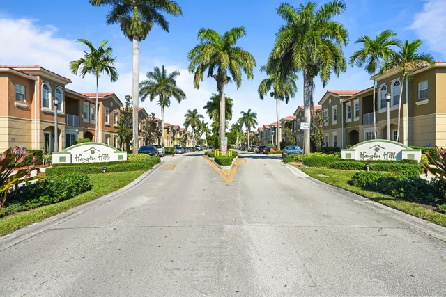 a view of multiple houses with palm trees