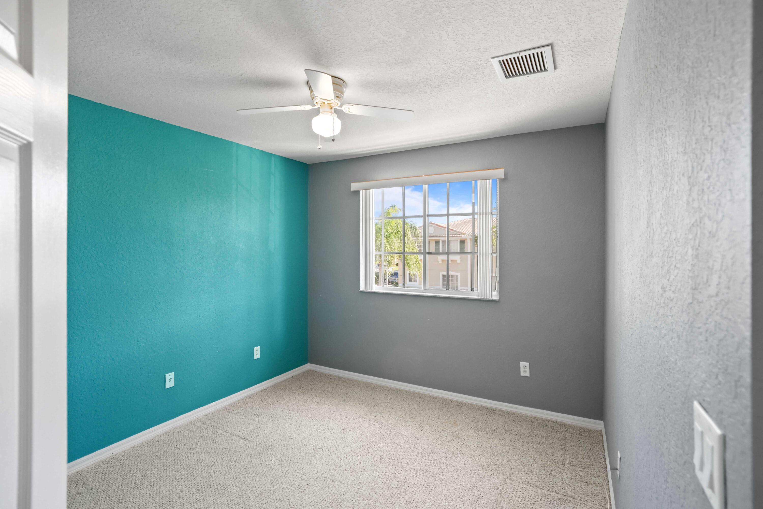 5961 London Lane Tamarac, FL 33321 - Photo 12 of 21 an empty room with windows and fan