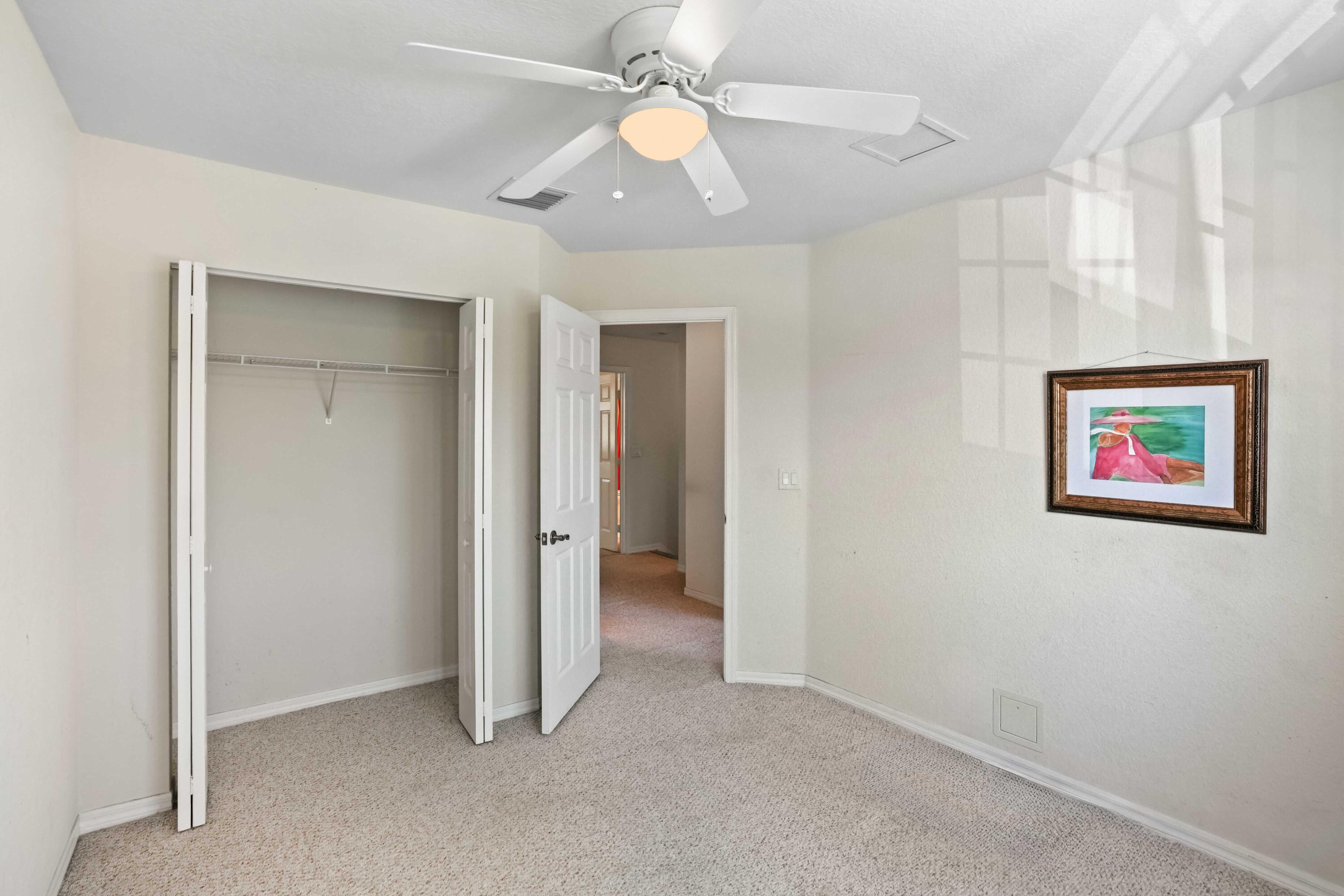 5961 London Lane Tamarac, FL 33321 - Photo 15 of 21 an empty room with closet and a ceiling fan