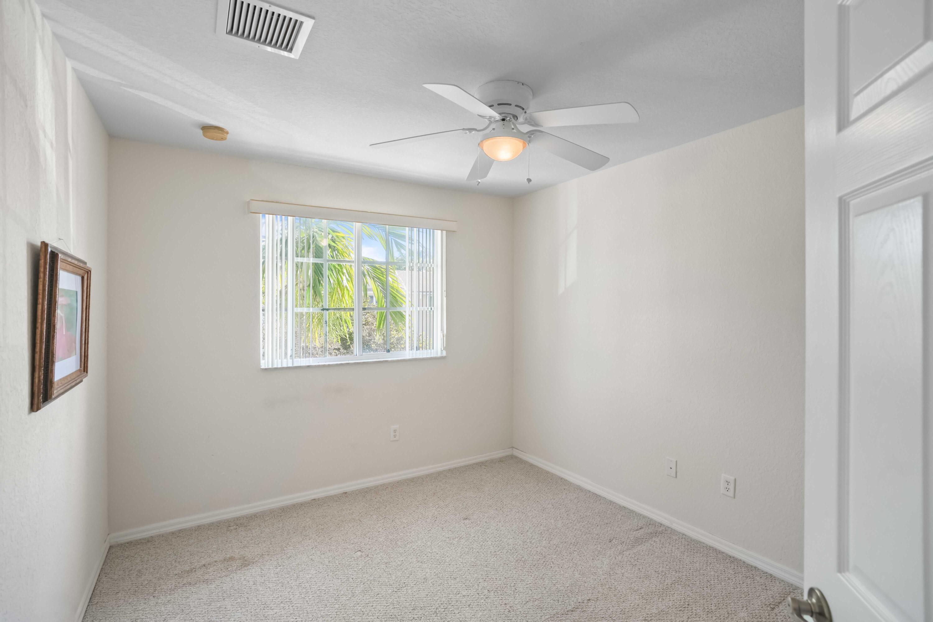 5961 London Lane Tamarac, FL 33321 - Photo 17 of 21 an empty room with windows and fan