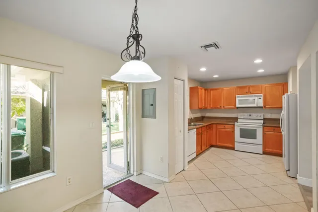 a open kitchen with stainless steel appliances granite countertop a refrigerator and a sink