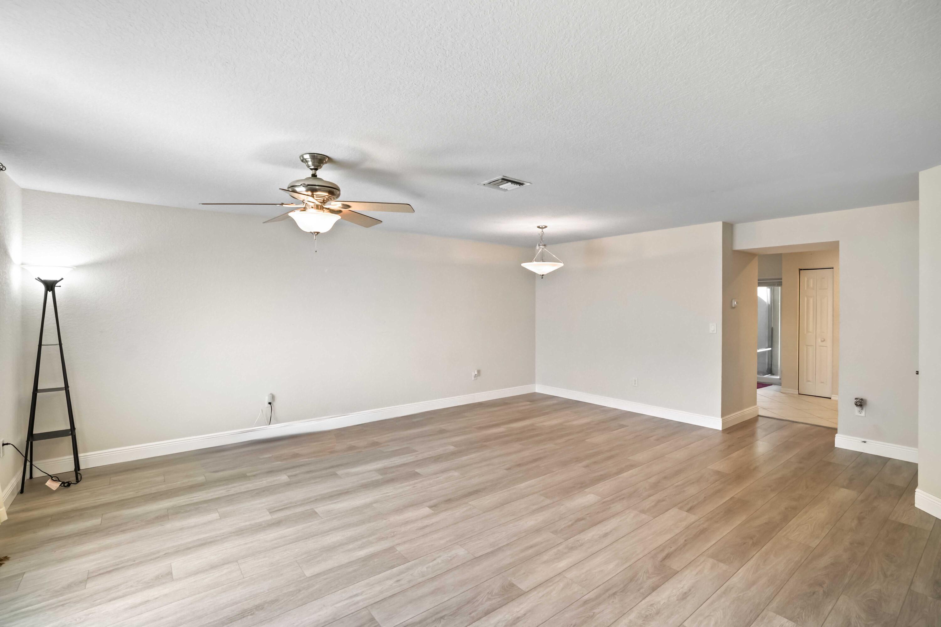 5961 London Lane Tamarac, FL 33321 - Photo 9 of 21 wooden floor in an empty room with a window