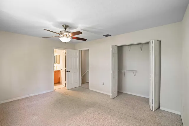 a view of an empty room with a ceiling fan