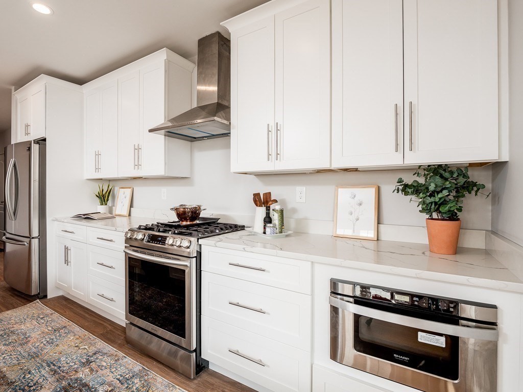 45 L Street, Unit 20 Boston, MA 02127 - Photo 16 of 28 a kitchen with stainless steel appliances granite countertop a stove a white cabinet and a granite counter tops