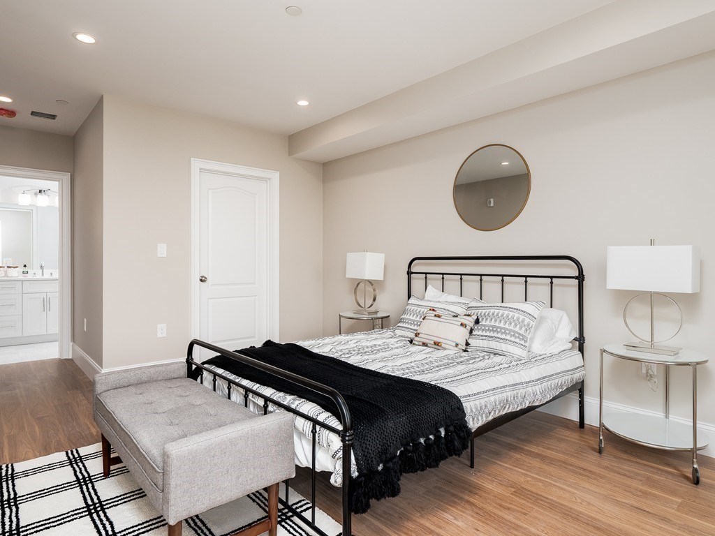 45 L Street, Unit 20 Boston, MA 02127 - Photo 20 of 28 a bedroom with a bed and wooden floor