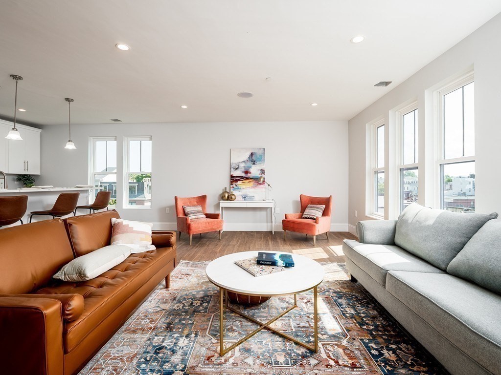 45 L Street, Unit 20 Boston, MA 02127 - Photo 2 of 28 a living room with furniture and a large window