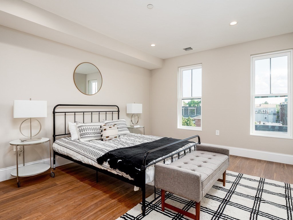 45 L Street, Unit 20 Boston, MA 02127 - Photo 21 of 28 a bedroom with a bed and a table