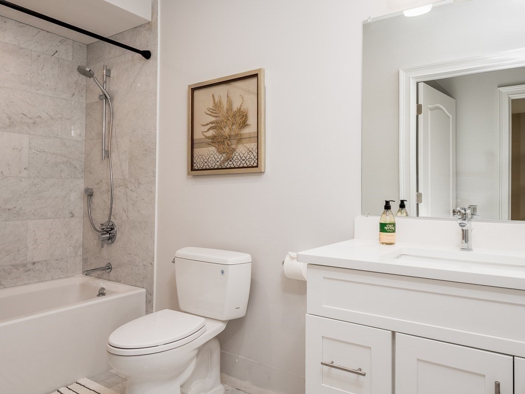 45 L Street, Unit 20 Boston, MA 02127 - Photo 22 of 28 a bathroom with a sink a toilet and a bathtub
