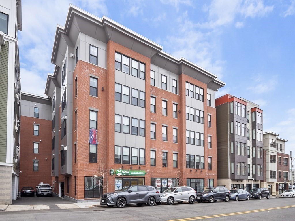 45 L Street, Unit 20 Boston, MA 02127 - Photo 28 of 28 a front view of a building with lot of cars and trees