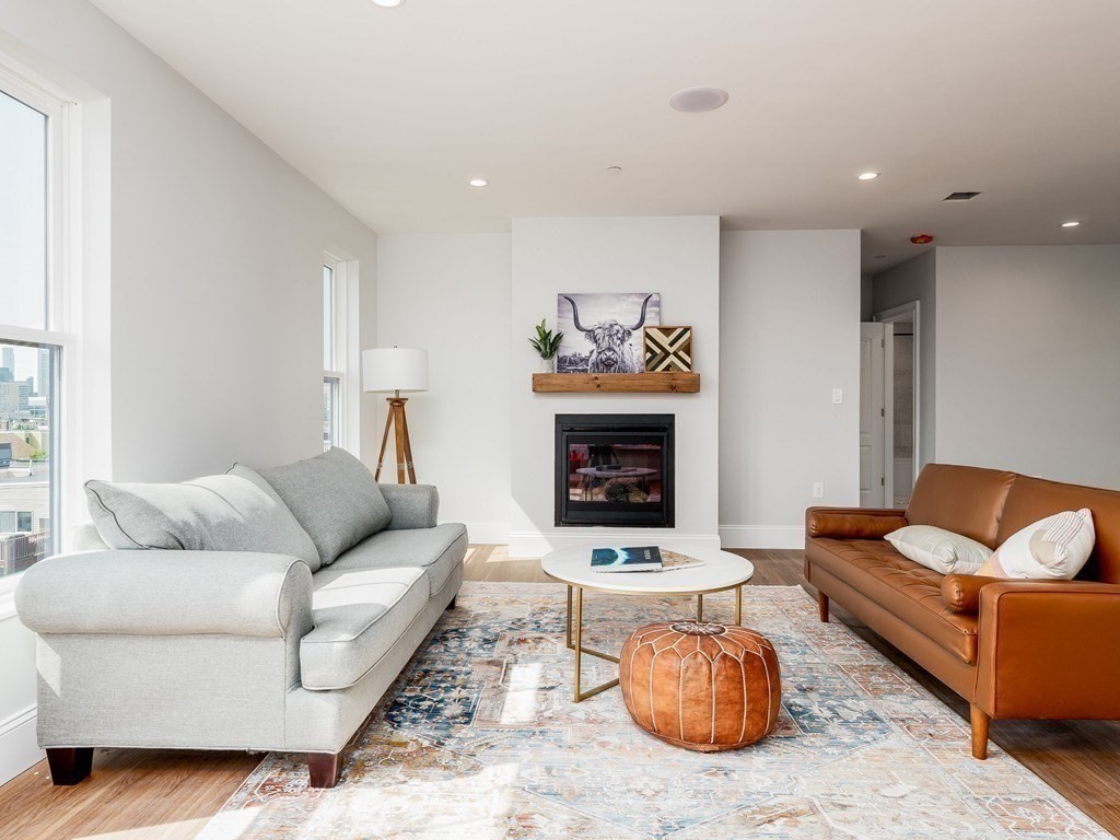 45 L Street, Unit 20 Boston, MA 02127 - Photo 5 of 28 a living room with furniture and a fireplace