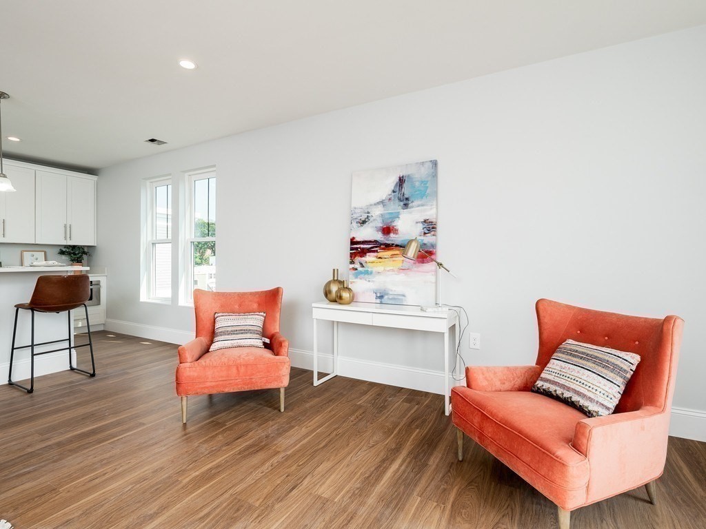 45 L Street, Unit 20 Boston, MA 02127 - Photo 6 of 28 a living room with furniture and a wooden floor