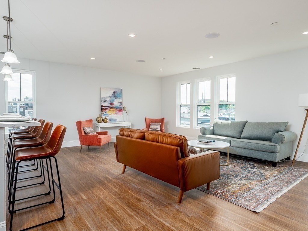 45 L Street, Unit 20 Boston, MA 02127 - Photo 7 of 28 a living room with furniture a wooden floor and a window