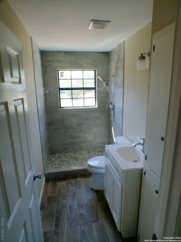 a bathroom with sink toilet and shower