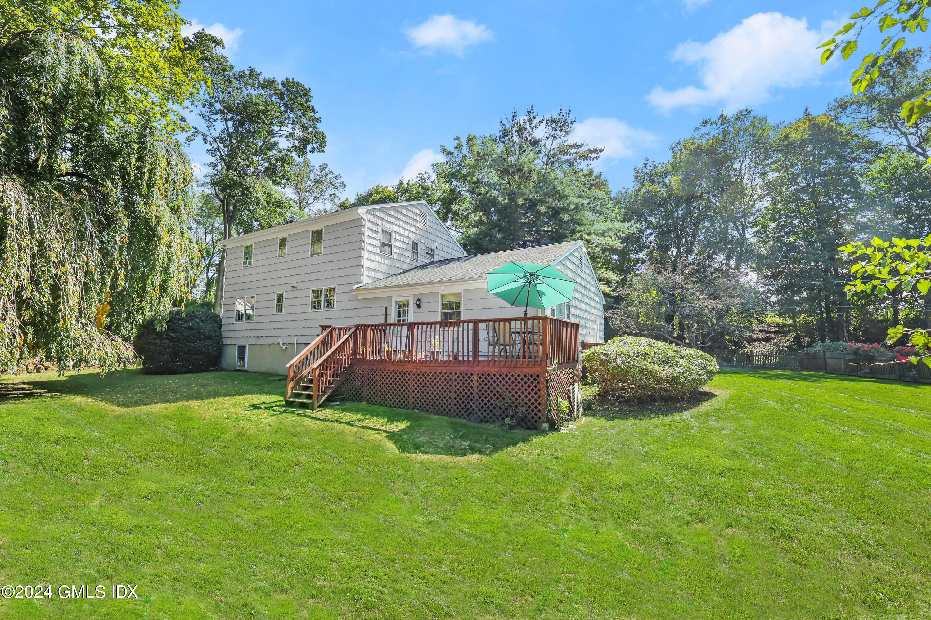 28 Juniper Lane Riverside, CT 06878 - Photo 1 of 22 a view of a house with a backyard and a patio