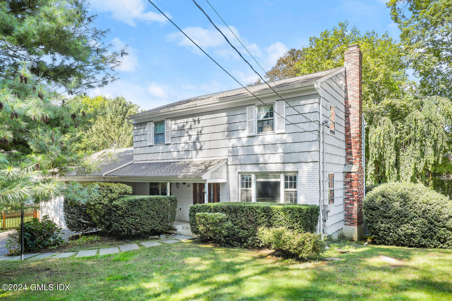 28 Juniper Lane Riverside, CT 06878 - Photo 16 of 22 a front view of a house with a yard