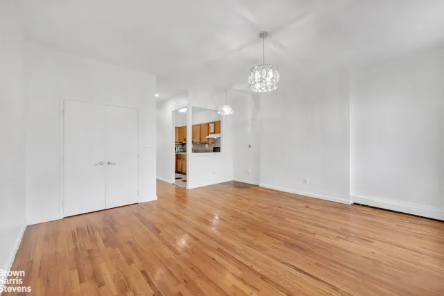 wooden floor chandelier and windows in a room
