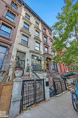 a front view of a building with outdoor seating