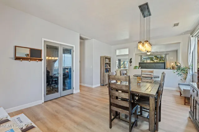 a view of a dining room with furniture and chandelier