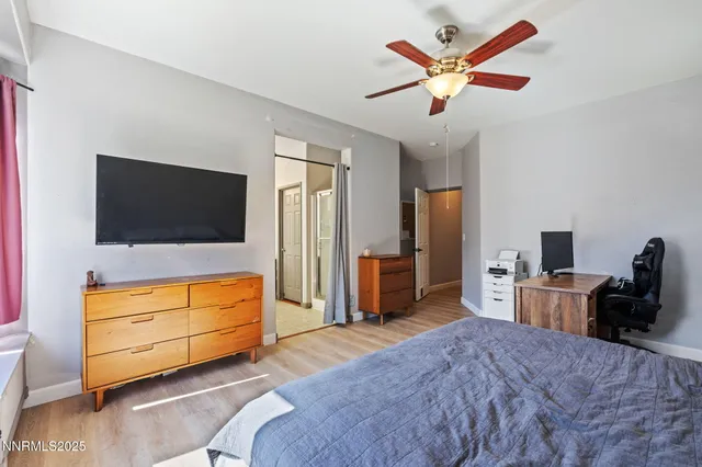a bedroom with bed and flat tv screen on dresser