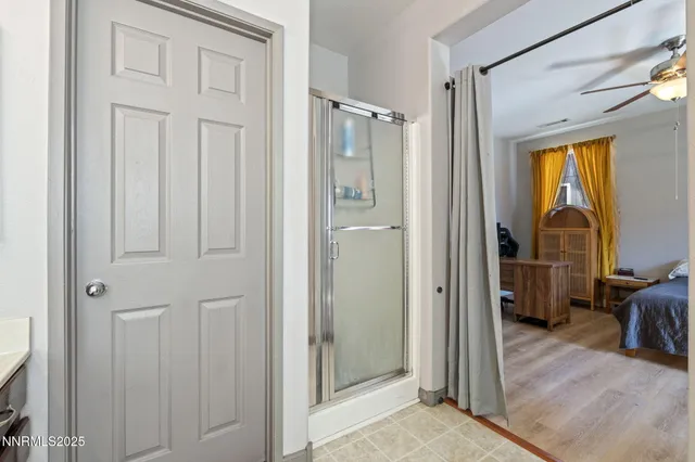 a view of a bathroom with closet and mirror