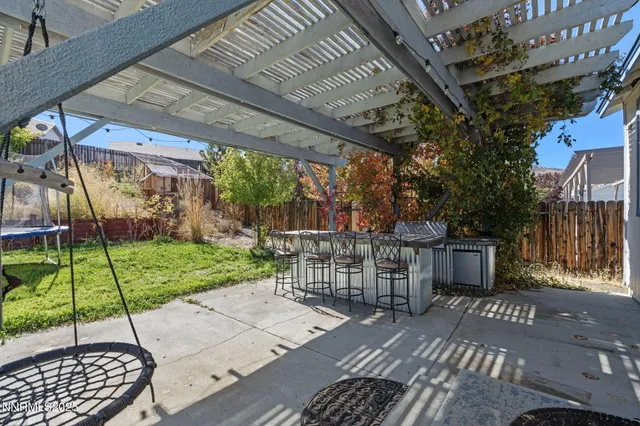 a view of a patio with a table and chairs