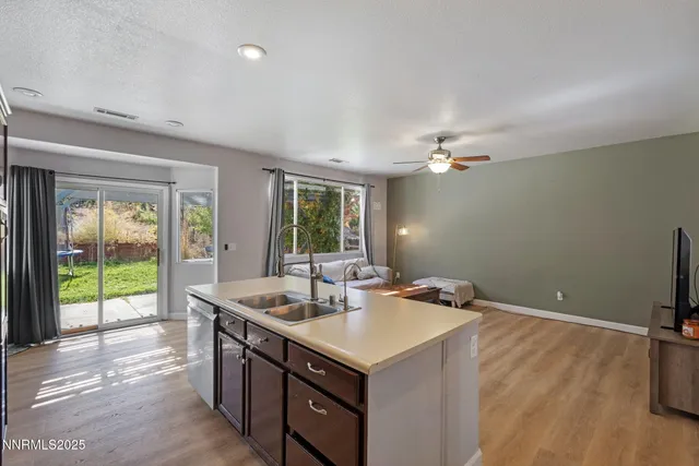 a kitchen with a sink cabinets and wooden floor