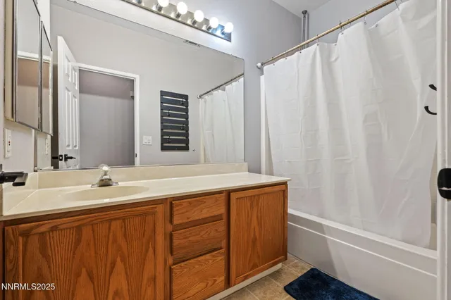 a bathroom with a double vanity sink and a mirror