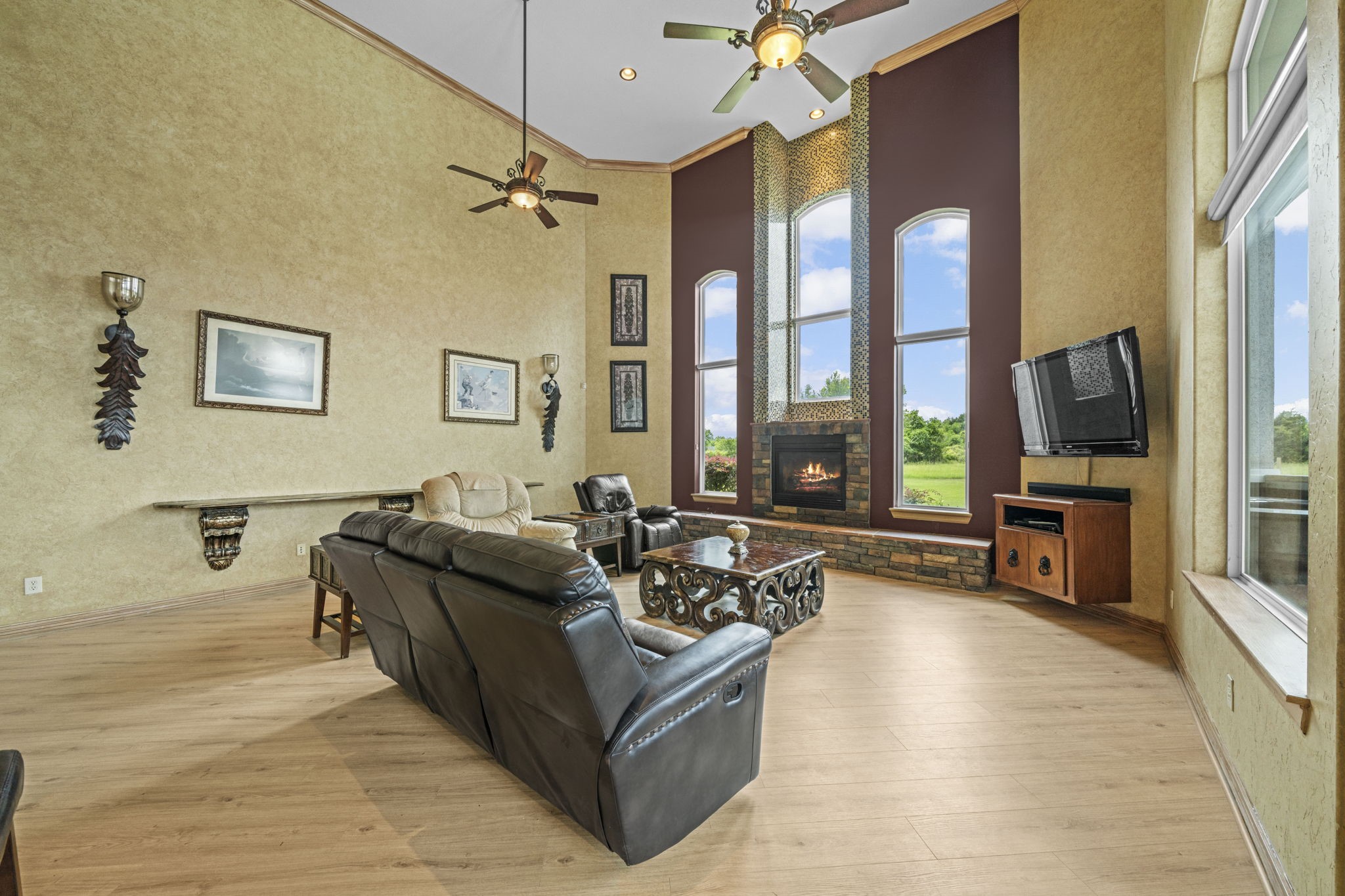 18732 Kz Road Cypress, TX 77433 - Photo 7 of 49 Dramatic 18ft ceilings, custom trim work, and walls of windows wrap this fireplace living room in pure comfort and custom style.