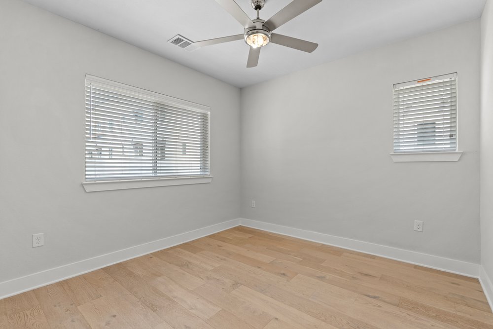 2827 Manor Road, Unit 2201 Austin, TX 78722 - Photo 19 of 40 Light wood-finish flooring with white baseboards and neutral wall paint