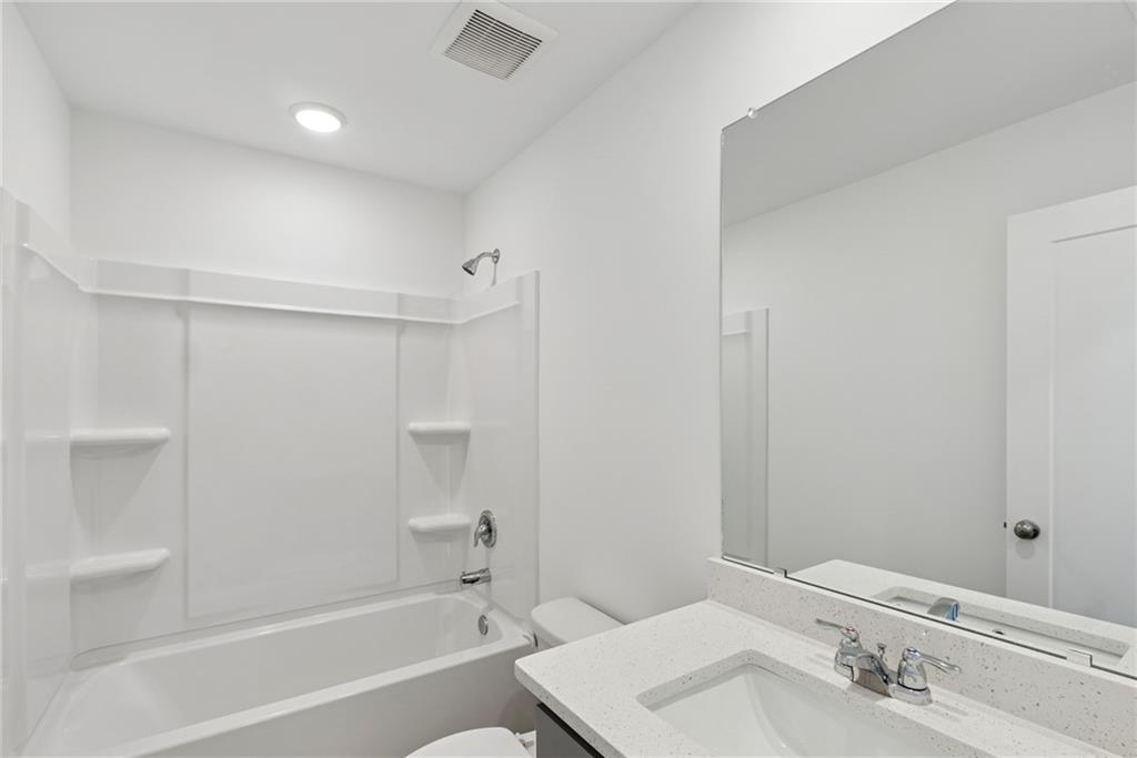 183 Redbud Road Canton, GA 30114 - Photo 13 of 16 a bathroom with a bathtub and a sink