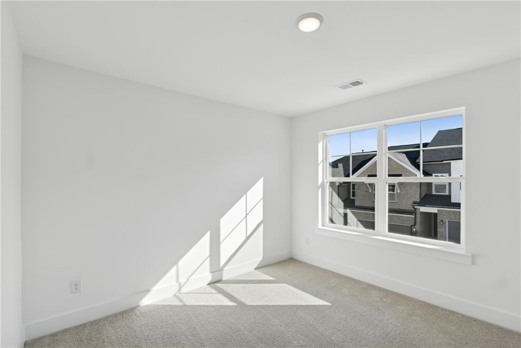 183 Redbud Road Canton, GA 30114 - Photo 14 of 16 a view of a house with a large window