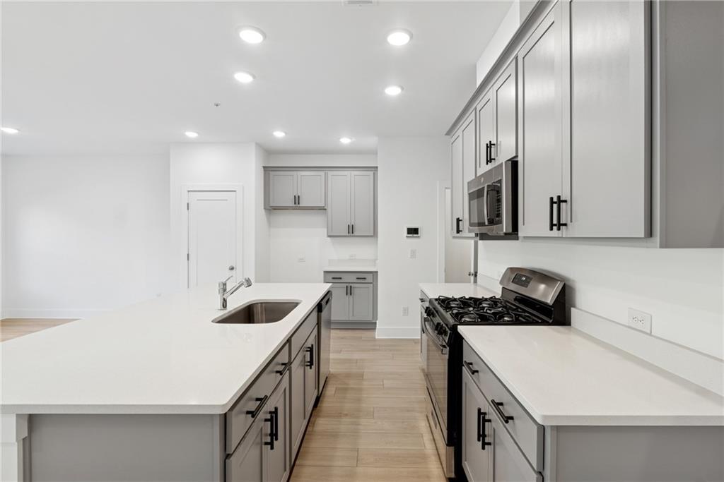 183 Redbud Road Canton, GA 30114 - Photo 6 of 16 a kitchen that has a sink and a stove