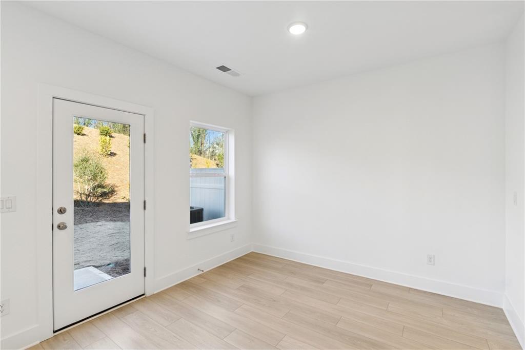 183 Redbud Road Canton, GA 30114 - Photo 8 of 16 a view of an empty room with wooden floor and a window
