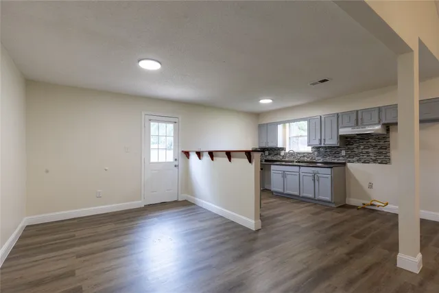 a view of kitchen with wooden floor and electronic appliances