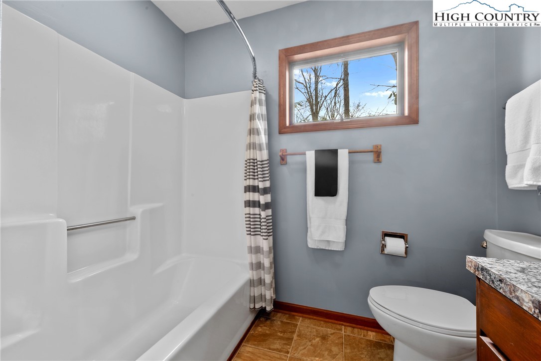 255 River Hollow Road Newland, NC 28657 - Photo 15 of 30 a bathroom with a toilet and a shower