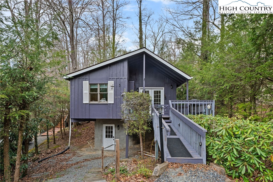 255 River Hollow Road Newland, NC 28657 - Photo 24 of 30 a roof deck with table and chairs under an umbrella