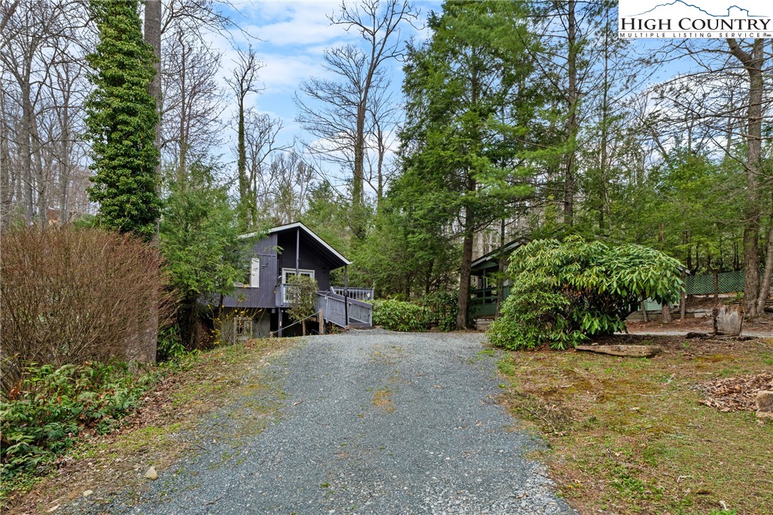 255 River Hollow Road Newland, NC 28657 - Photo 28 of 30 a view of a house with a yard and large trees