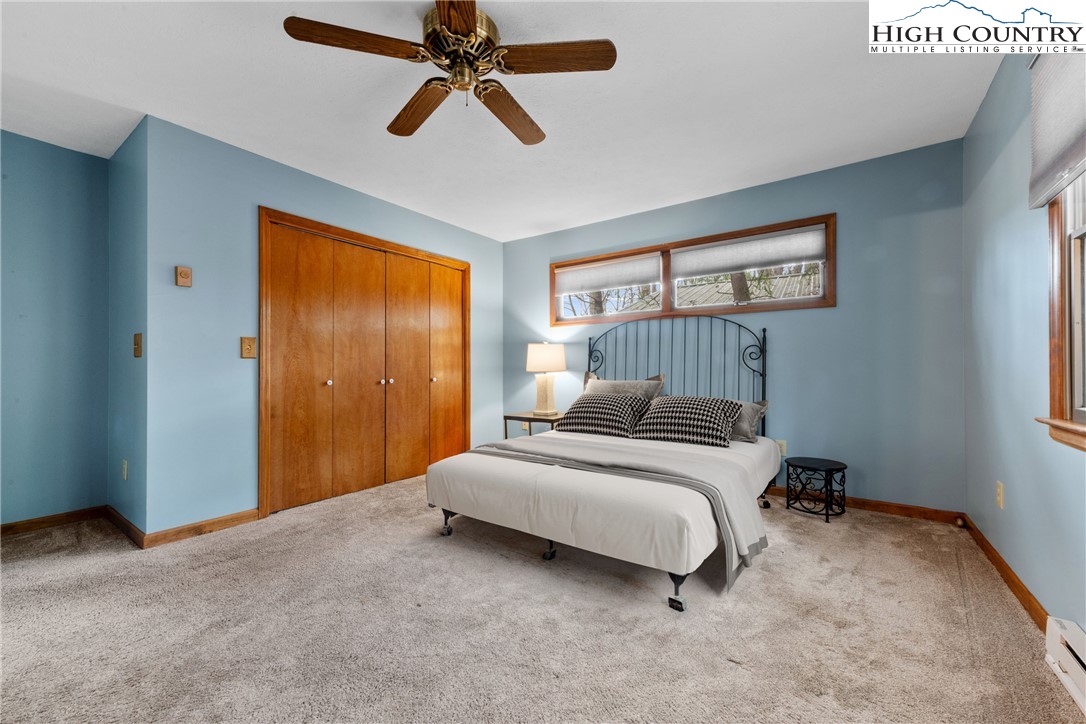 255 River Hollow Road Newland, NC 28657 - Photo 7 of 30 a bedroom with a bed and a chandelier