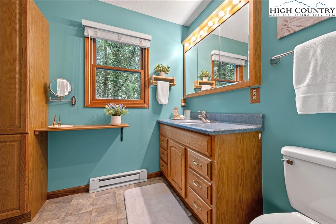 255 River Hollow Road Newland, NC 28657 - Photo 8 of 30 a bathroom with a sink a toilet and a mirror