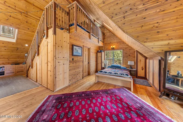 a bedroom with furniture and a wooden floor
