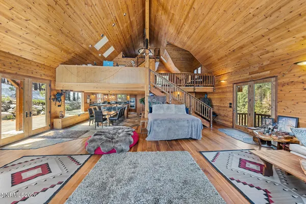 a bedroom with furniture and a wooden floor
