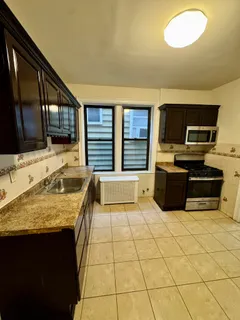 a kitchen with stainless steel appliances granite countertop a sink and a stove