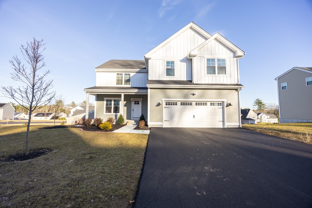 a front view of a house with yard and garage